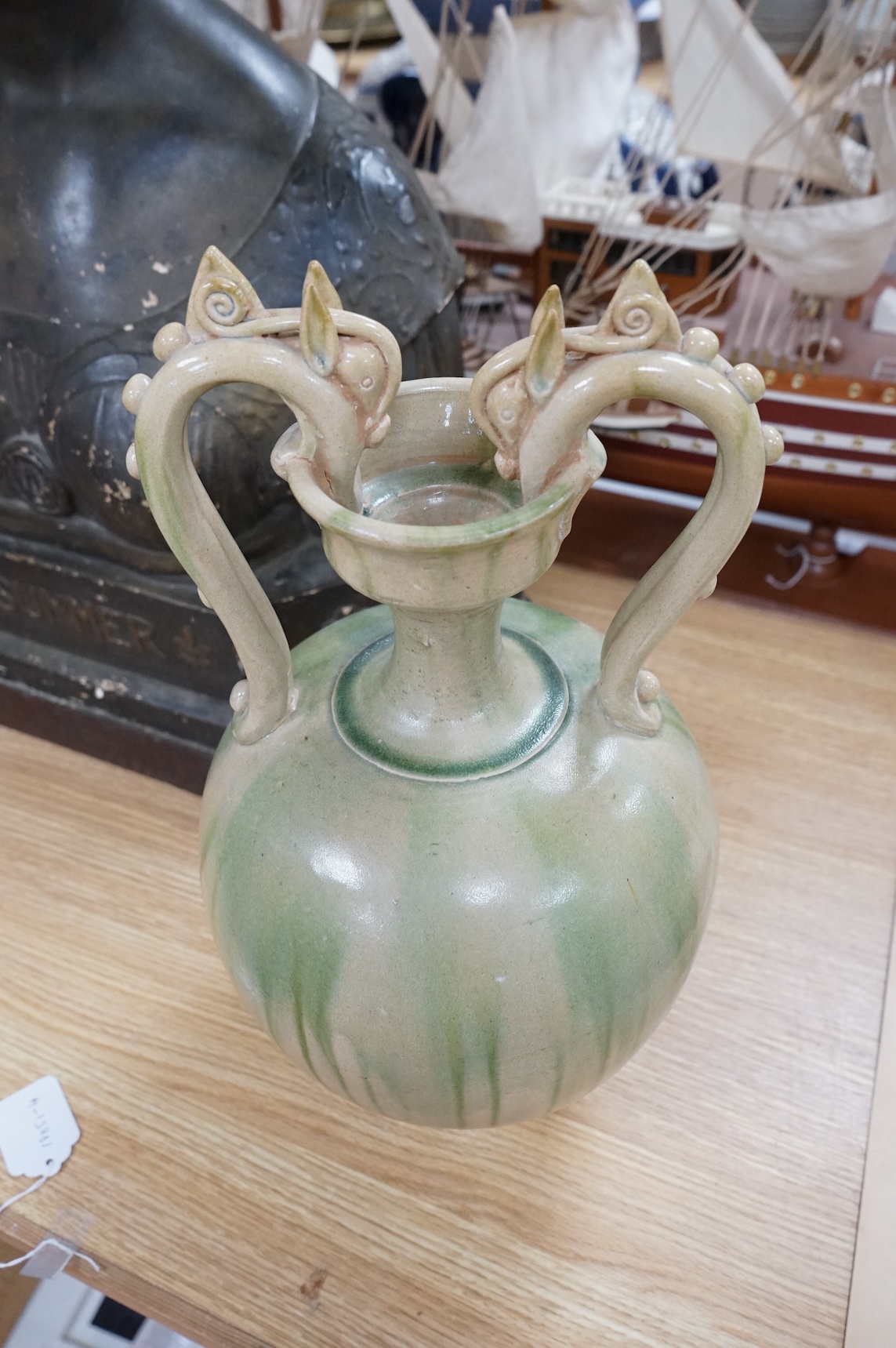 A Chinese green glazed terracotta ‘dragon’ handle vase, 42cm